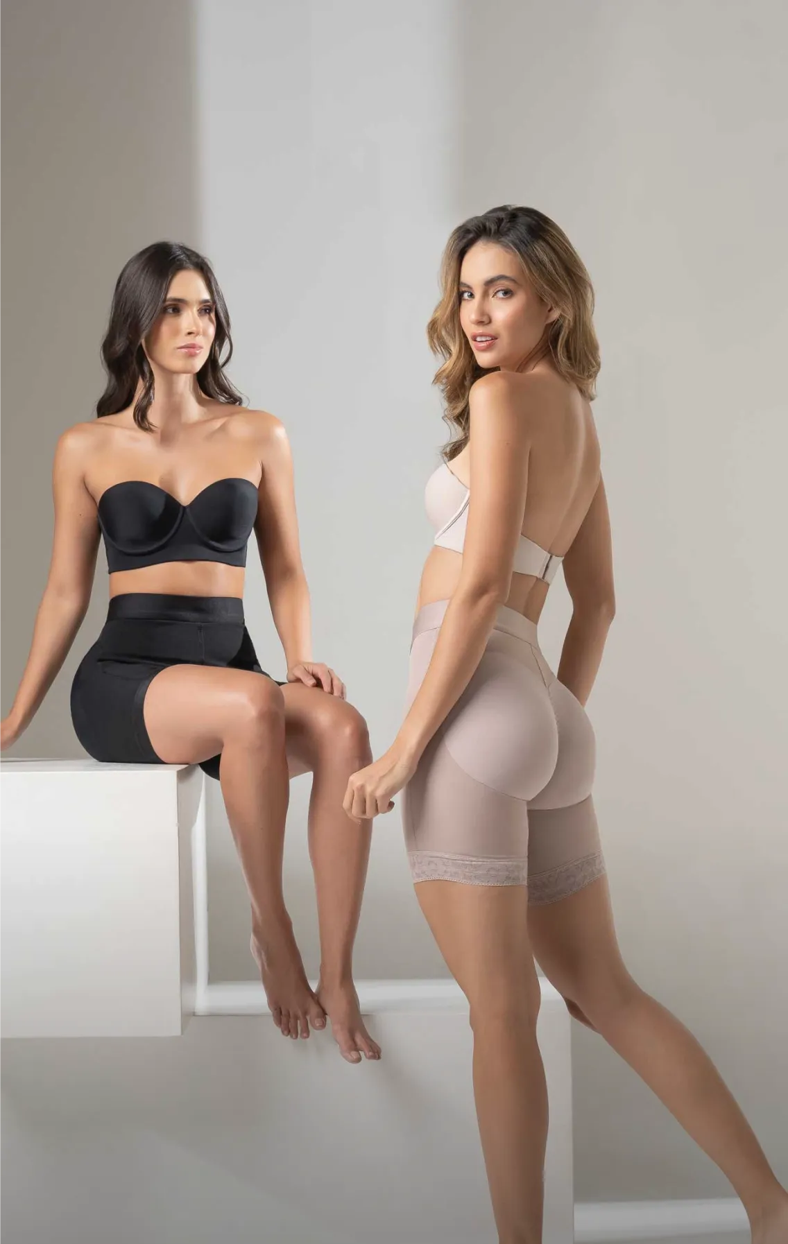 Two women wearing CYSM shaping shorts in black and nude, posing together with the message: Shaping is better together – One for you, one for your besties